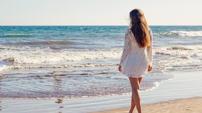 Woman walking towards Ocean